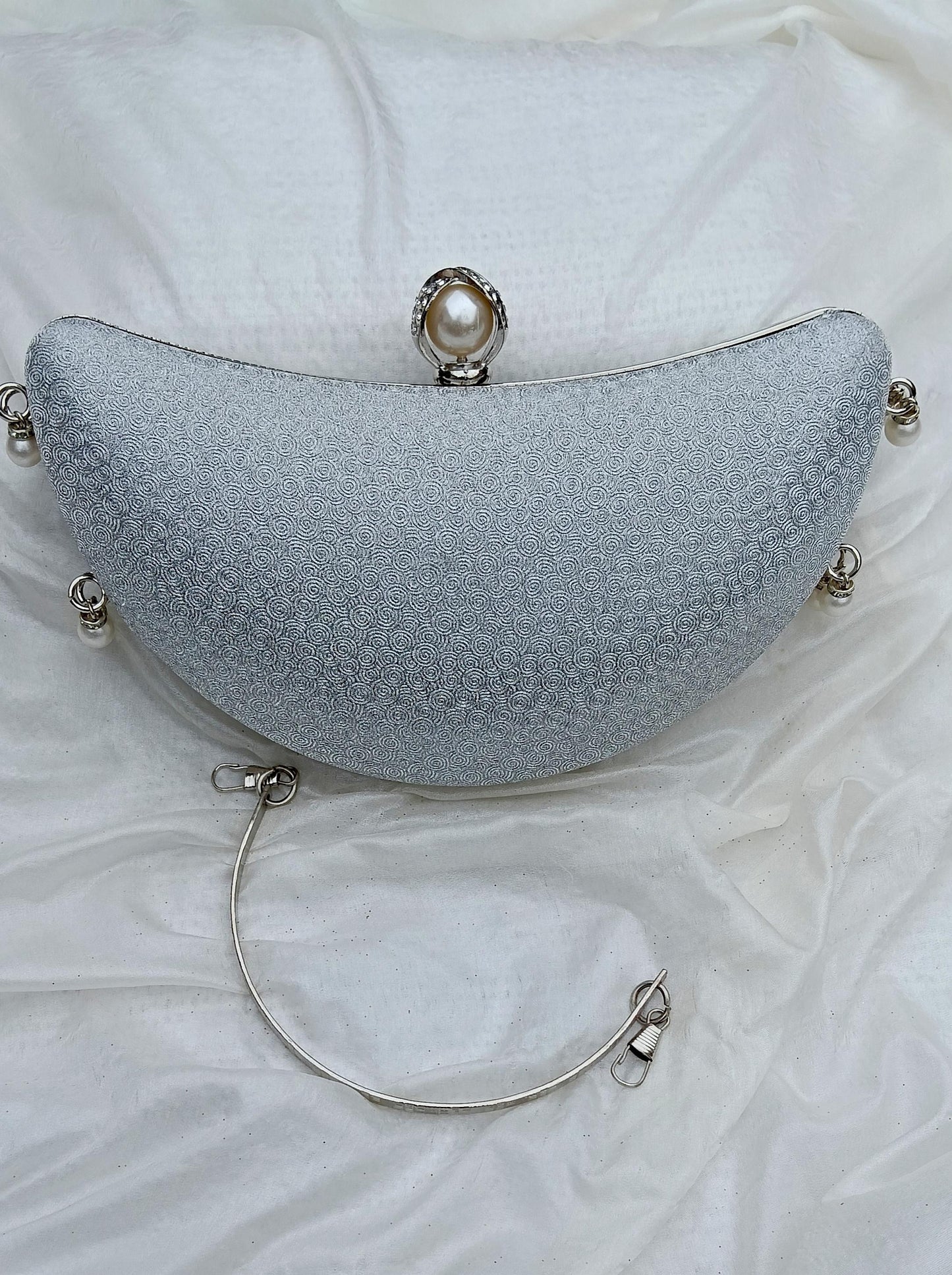 Noor Crescent clutch in silver with elegant half-moon design, wedding clutch by The Silken Chic